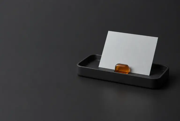 A blank slip held in a black tray by a small amber stopper